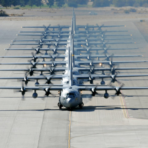 A line of C-130 Hercules taxi at Nellis Air Force Base, Nevada.