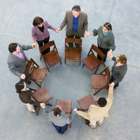 Businesspeople holding hands in a circle